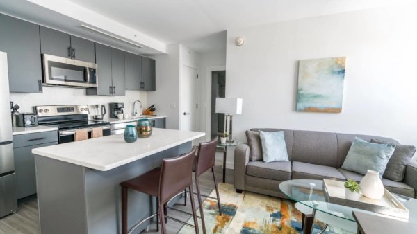 Open plan living area including granite counter tops and stainless steel appliances