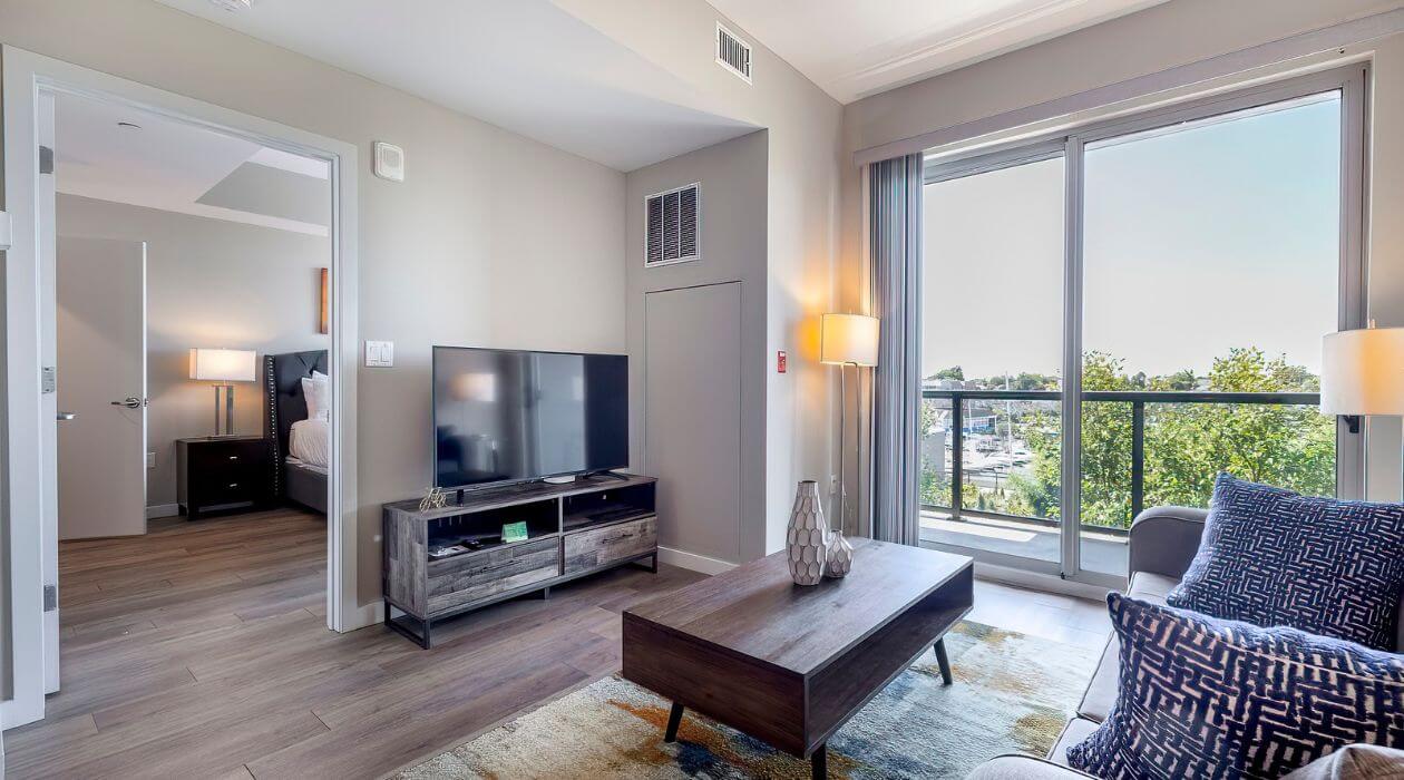 Living room at Escape at Harbor Point by Compass Furnished Apartments