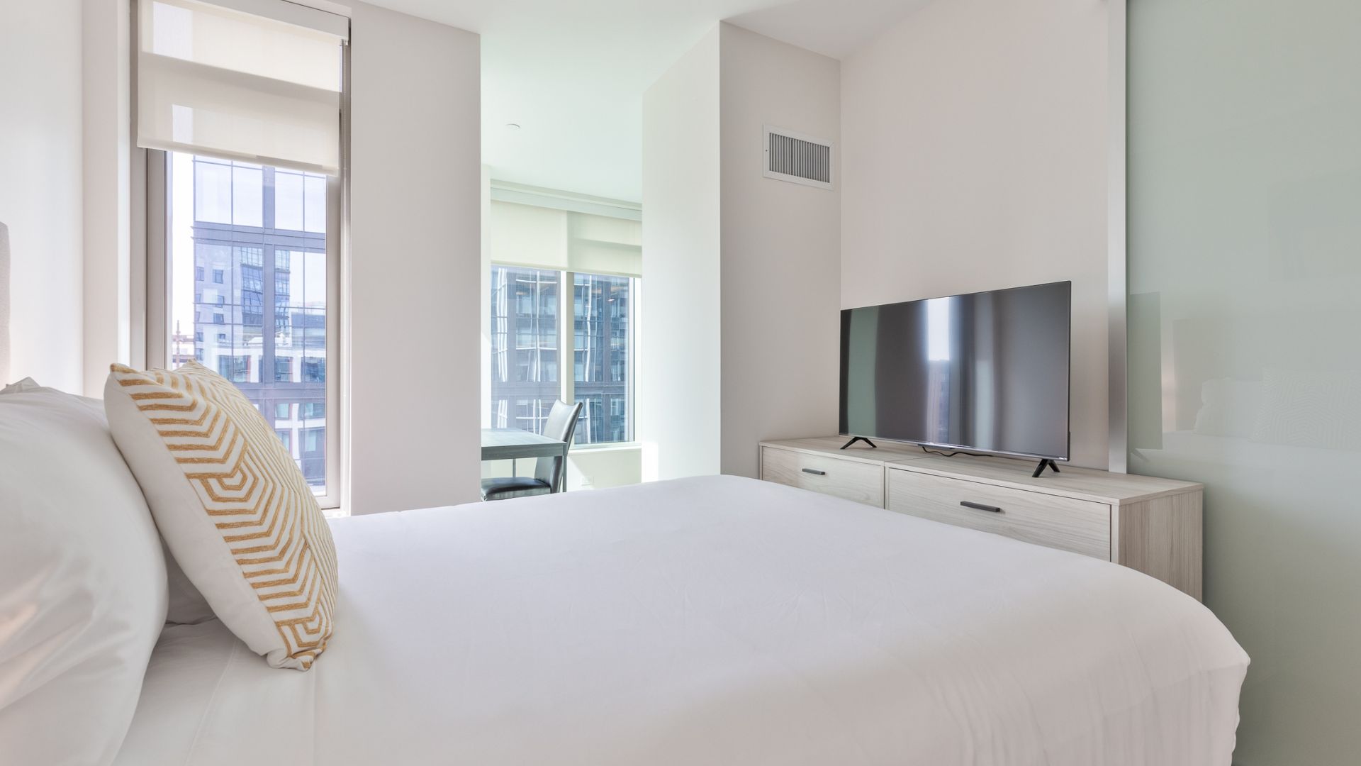 Modern bedroom at The Alyx at EchelonSeaport by Compass Furnished Apartments.