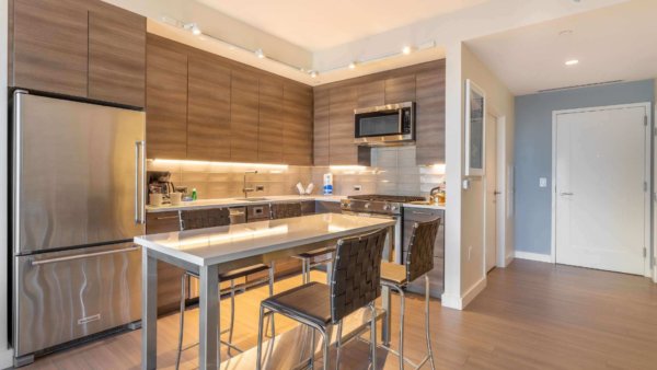 Sleek modern kitchen in furnished short term rental, fully equipped for weeknight dinners, complemented by hassle-free apartment turnkey services