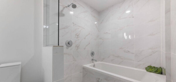 White-tiled bathroom at Solitair Brickell – Compass Furnished Apartments