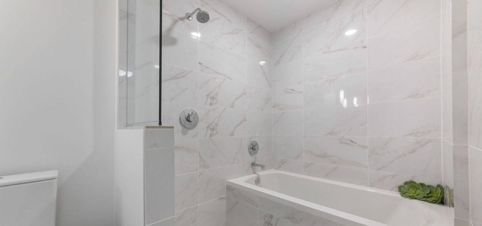 White-tiled bathroom at Solitair Brickell – Compass Furnished Apartments