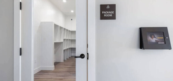 Secure and organized package room at The Avery by Compass Furnished Apartments, featuring labeled storage cubbies and a digital package management system.