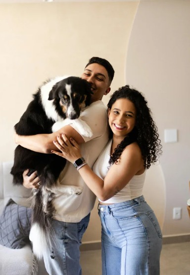 happy couple and a dog at home square