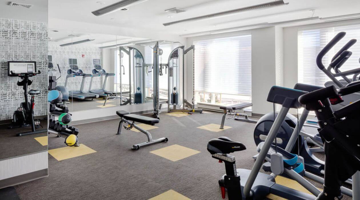 Modern fitness center at Compass Furnished Apartments' Chroma property
