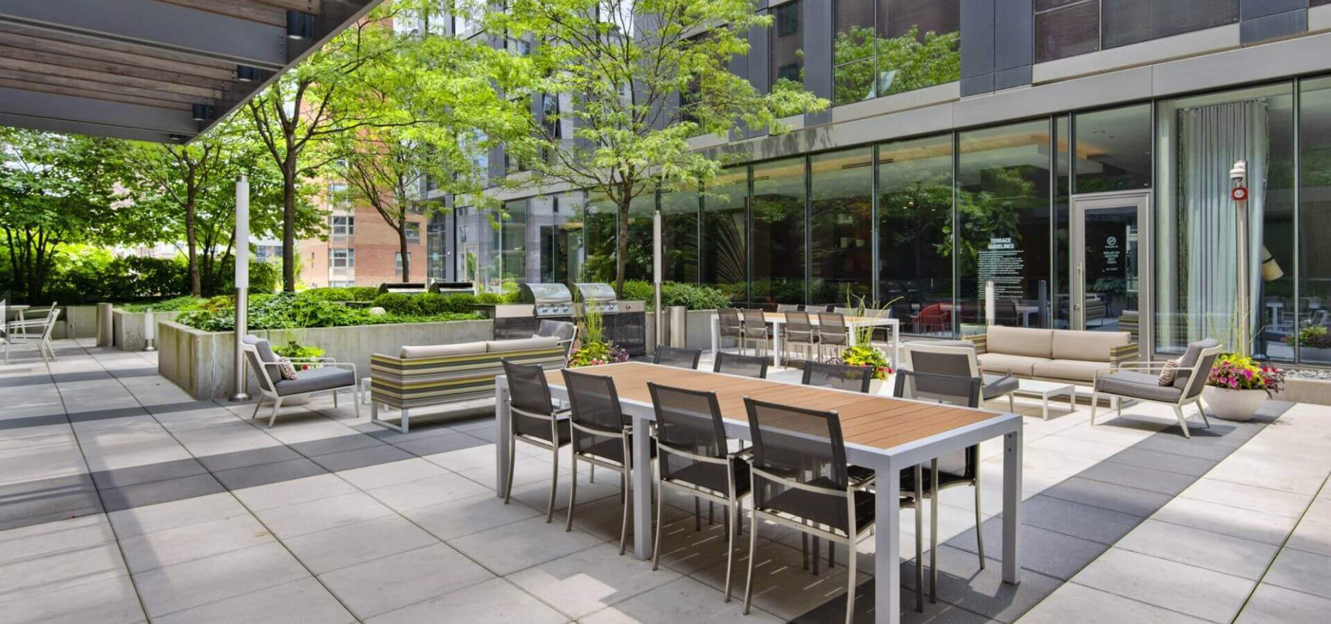 Outdoor courtyard lounge at State & Chestnut, a Compass Furnished Apartments property 1