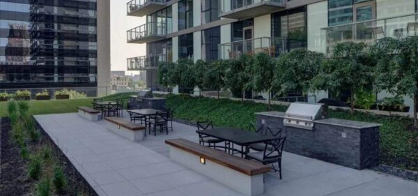 Outdoor grilling and dining terrace at Catalyst, a Compass Furnished Apartments property