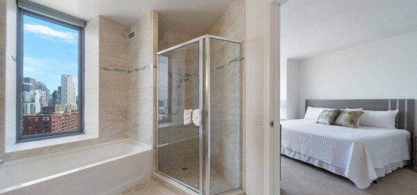 Bathroom & Bedroom at Catalyst in Chicago, a Compass Furnished Apartments property