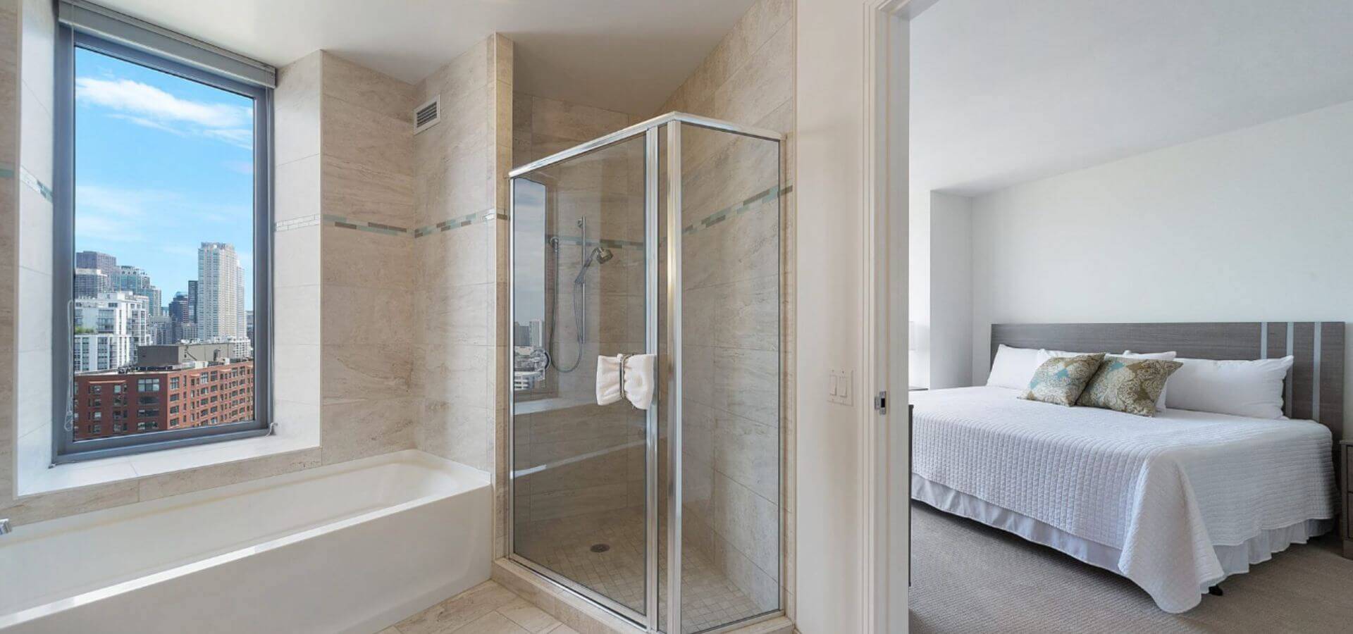 Bathroom & Bedroom at Catalyst in Chicago, a Compass Furnished Apartments property
