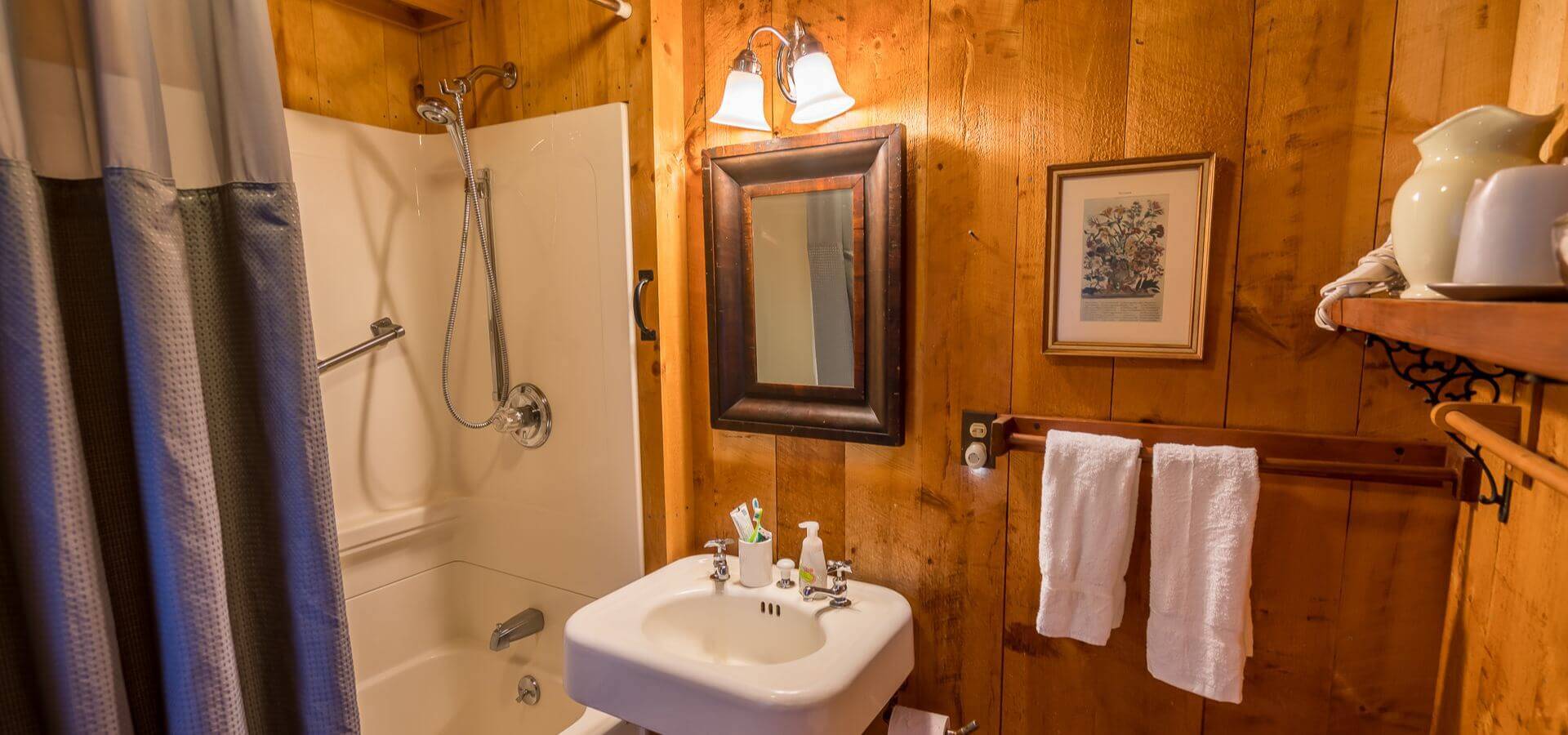 A warmly lit rustic bathroom at 1292 Middletown managed by Compass Furnished Apartments
