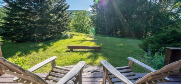 Outdoor deck with Adirondack chairs at 1292 Middletown, a Compass Furnished Apartments home 1