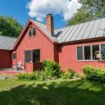 Exterior view of the red cottage-style home at 1292 Middletown by Compass Furnished Apartments