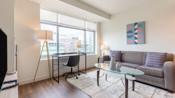 Modern Living Room with Desk at Watermark Kendall West #306 | Compass Furnished Apartments