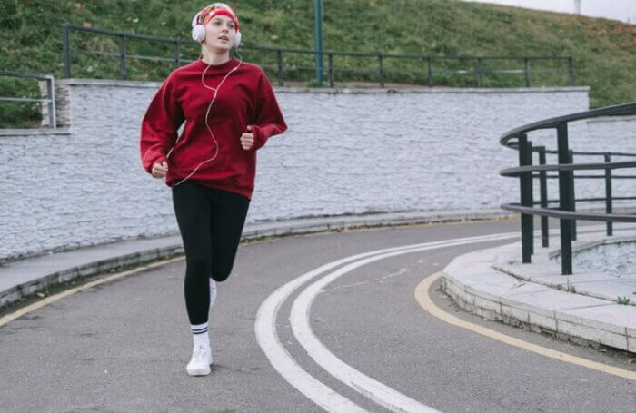 A fit woman runs outside in Boston