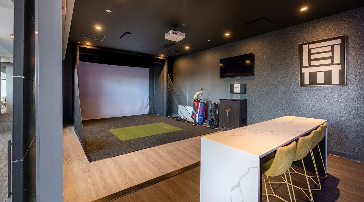 Golf simulator and lounge area at 3Thirty3 by Compass Furnished Apartments