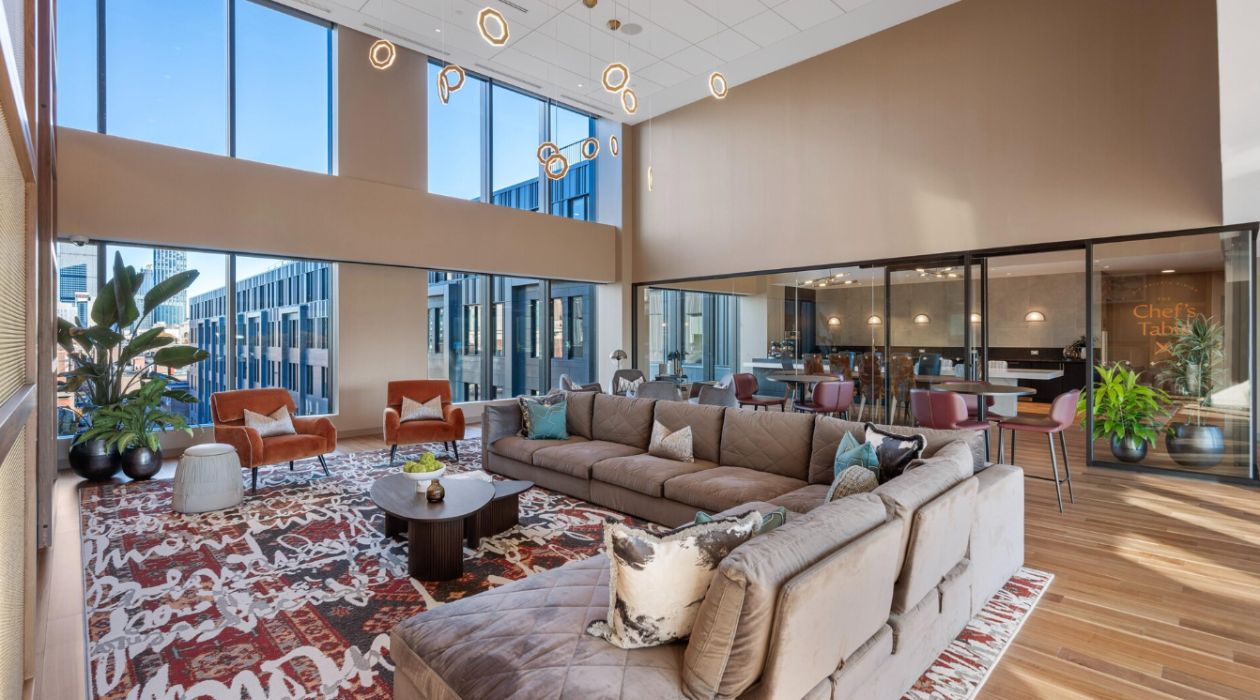 Spacious two-story lounge at Idyl Fenway by Compass Furnished Apartments