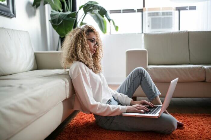 a woman works on her laptop in housing for medical students