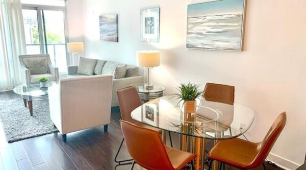 Bright open-concept living and dining area at Compass Furnished Apartments’ Skydome City