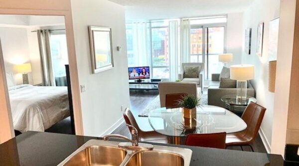 Modern open-concept apartment at Compass Furnished Apartments’ Skydome City