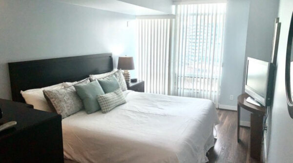 Bright bedroom at Compass Furnished Apartments’ Skydome City