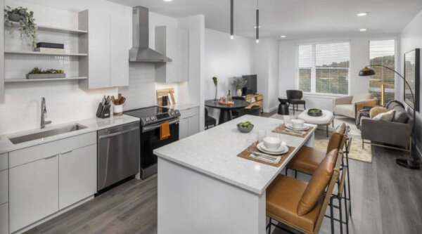 Modern furnished apartment kitchen and living room at The 305 – Compass Furnished Apartments