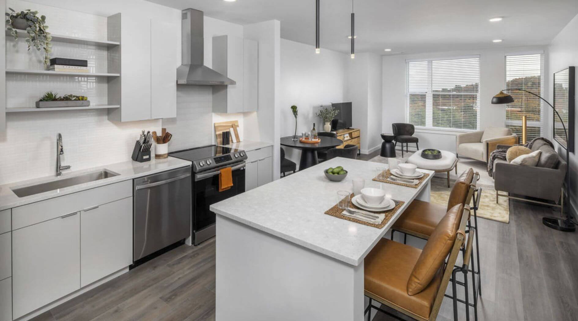 Modern furnished apartment kitchen and living room at The 305 – Compass Furnished Apartments