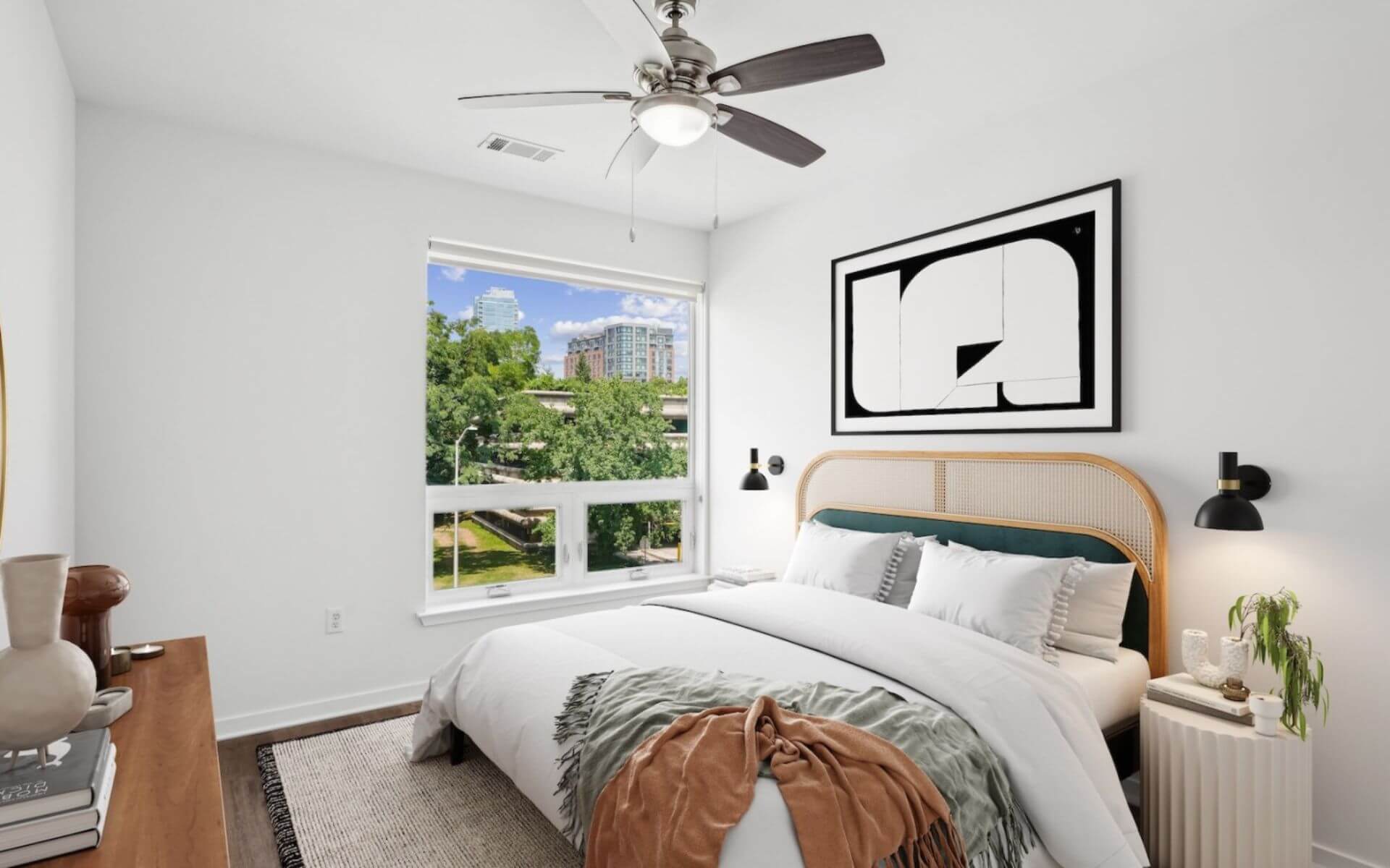 Bright, modern bedroom with large window and city views at 75 Tresser, managed by Compass Furnished Apartments.