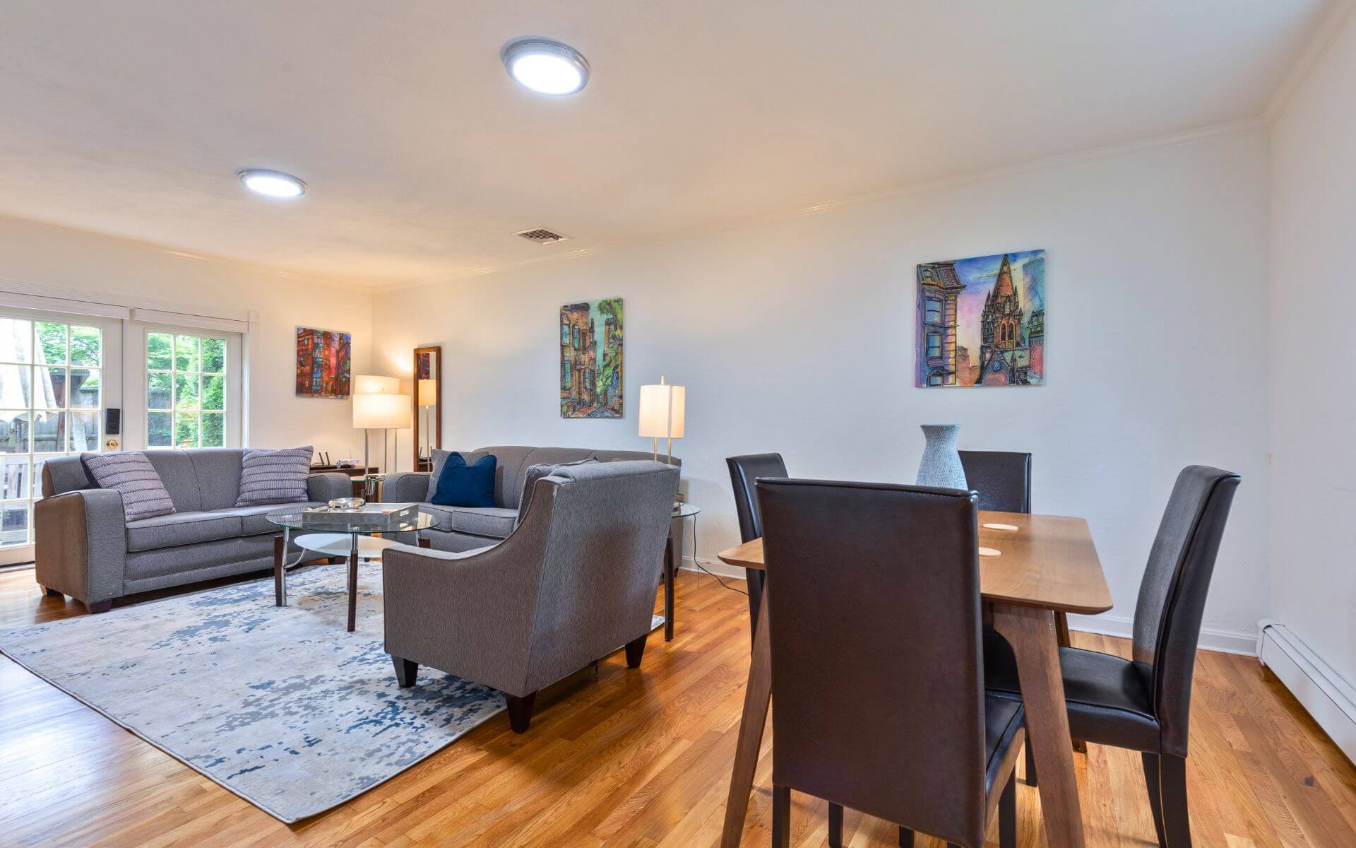 Open-concept living and dining area at 235 Cardinal Medeiros with stylish furniture, hardwood floors, and modern decor.