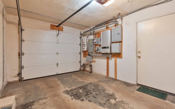 Attached garage at 235 Cardinal Medeiros by Compass Furnished Apartments, featuring a clean space and utility panels.