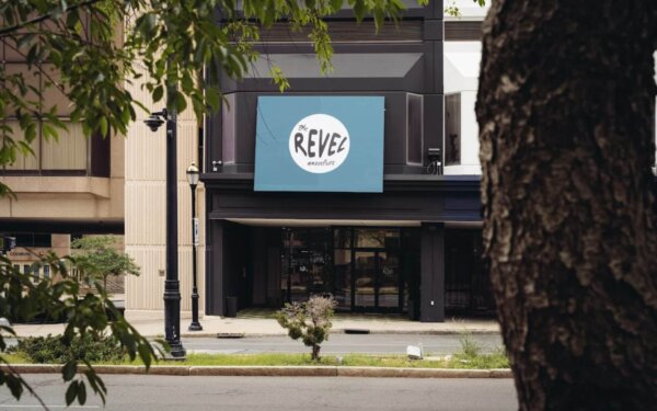 Street view of the entrance to The Revel by Compass Furnished Apartments