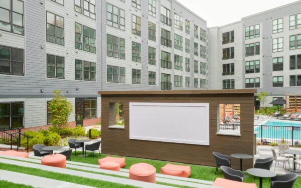 Open-air movie screening area at The Pennant at North Crossing by Compass Furnished Apartments