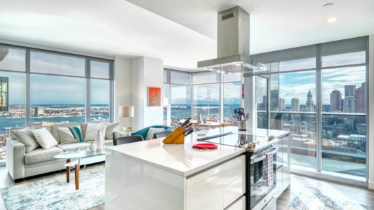 Fully equipped kitchen in a corporate housing unit, featuring modern appliances and a dining area suitable for hosting business discussions.