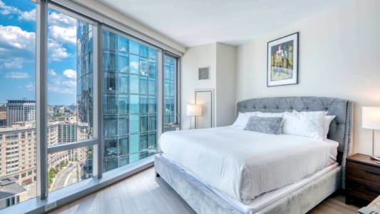 30 Dalton Unit 2002 Bedroom modern furnished bedroom in a business travel acommodation with a tv, kitchen, spacious work desk, and high-speed internet