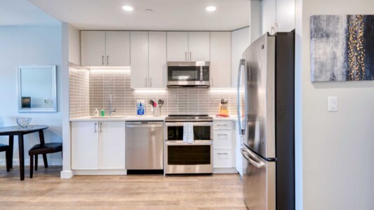 One Chestnut Place Unit 1107 Kitchen modern furnished kitchen in a bright business short-term rental apartment with a tv, spacious work desk, and high-speed internet